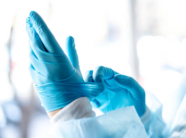 istock Medicine and Surgery theme: doctor putting on protective blue gloves 1291235888