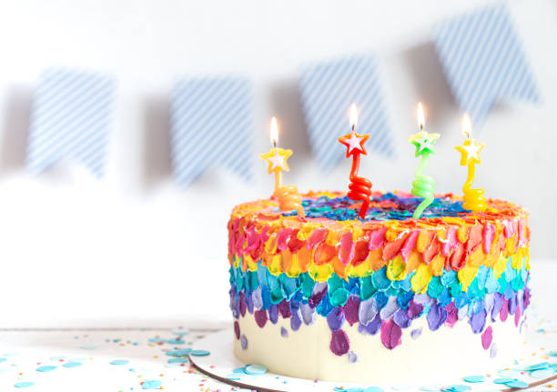 istock Colorful big handmade birthday cake with burning candles. 1291237718