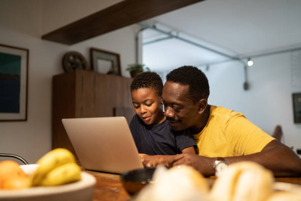 istock Grandfather helping grandson studying or working at home 1291238199