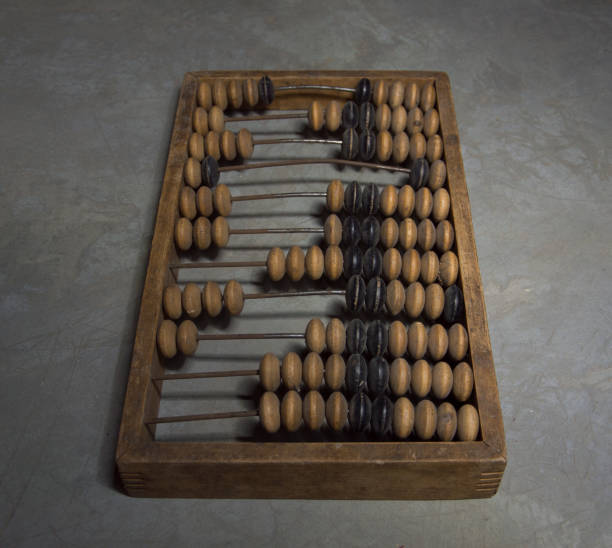 istock Old wooden abacus on a gray background. 1291238392