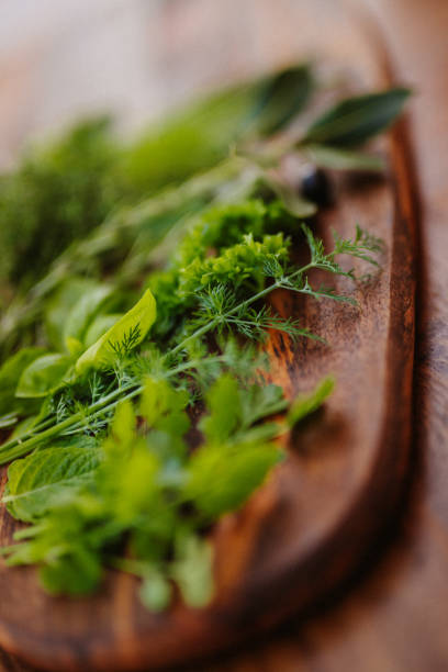 istock Green fresh herbs on a rustic wooden board with the main focus on the dill 1291239902