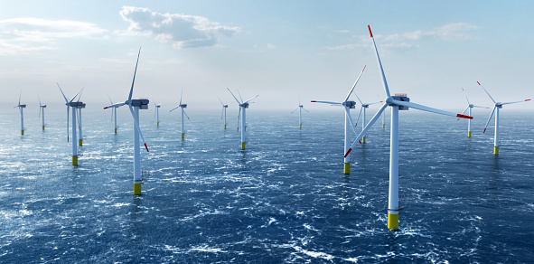 Offshore wind power and energy farm with many wind turbines on the ocean. Sustainable electricity production