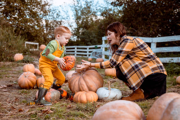 istock Mother and son in pumpkin patch 1291240806