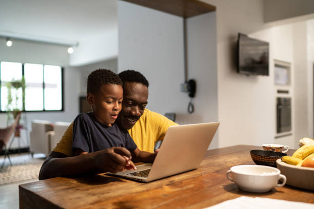 Grandfather helping grandson studying or working at home