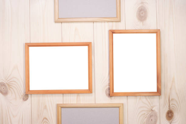 istock Mock up empty wood frames on light pine wood wall background, show text or product. 1291241858