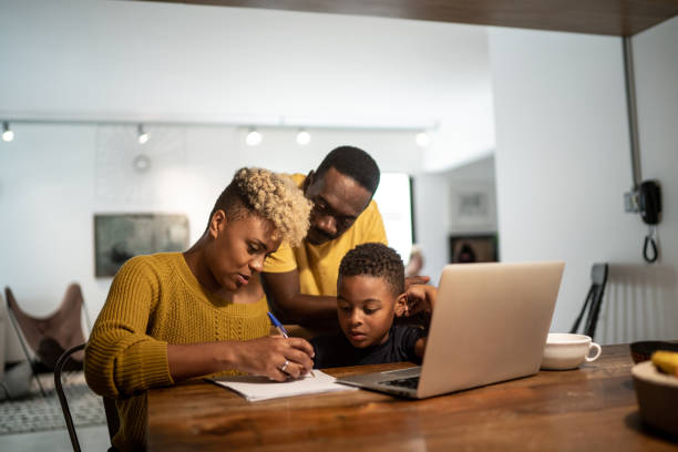 istock Parents teaching son studying at home 1291242623