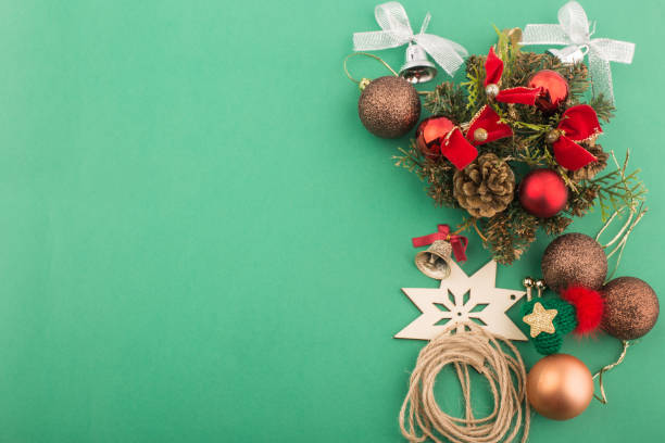 istock Christmas ornaments and decorations on green background. 1291243876