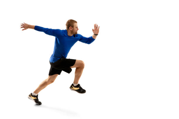 istock Caucasian professional runner, jogger training isolated on white studio background in fire 1291244640