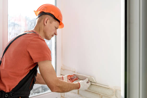 istock The worker is installing gypsum brick tiles on the wall. 1291244758