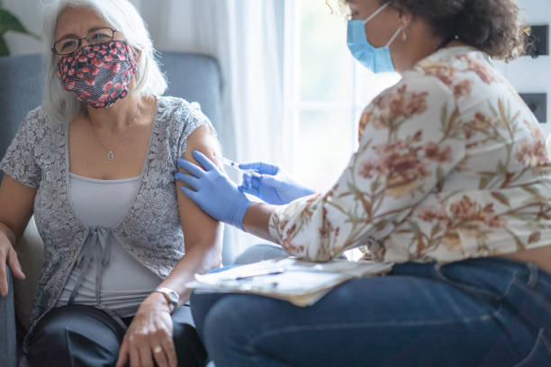 istock Senior Filipino patient wearing face mask getting vaccination 1291245404