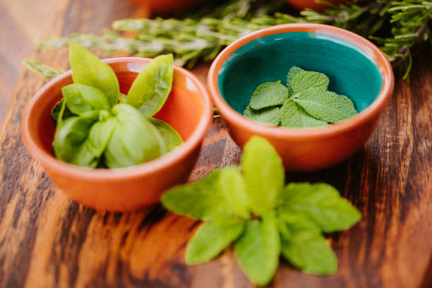istock Different green herbs in bowls with focus on the sage 1291245830