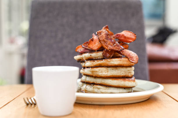 istock Pancake stack with golden syrup and a large portion of bacon as a breakfast or brunch meal 1291246251