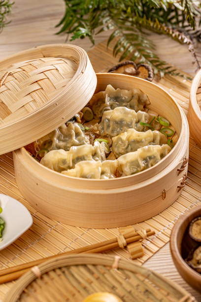 istock Bamboo steamer with tasty dumplings 1291246303