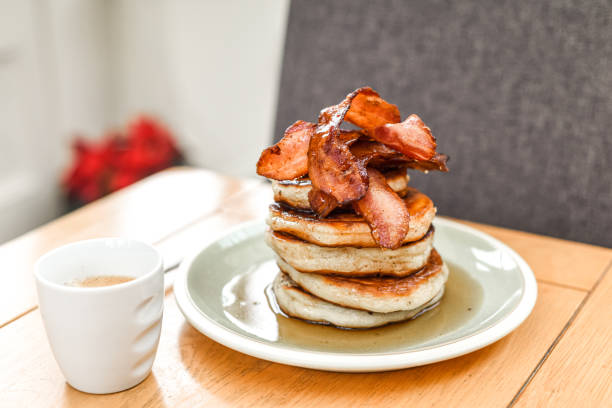 istock Pancake stack with golden syrup and a large portion of bacon as a breakfast or brunch meal 1291246319