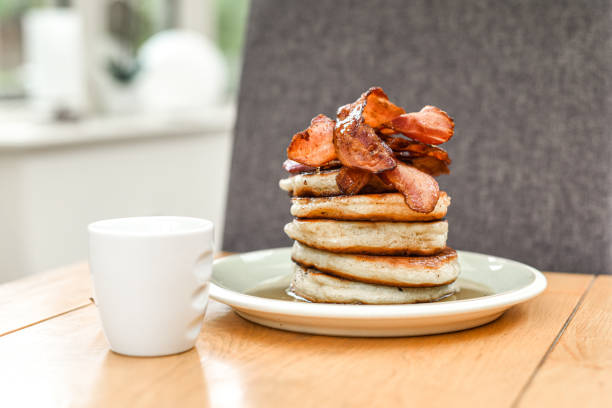 istock Pancake stack with golden syrup and a large portion of bacon as a breakfast or brunch meal 1291246321