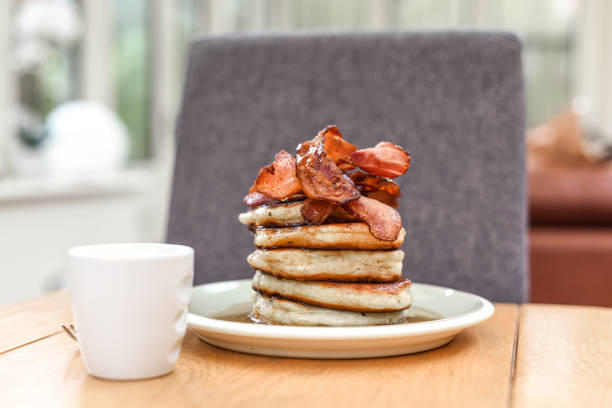 istock Pancake stack with golden syrup and a large portion of bacon as a breakfast or brunch meal 1291246414