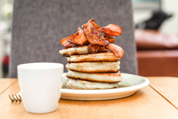 istock Pancake stack with golden syrup and a large portion of bacon as a breakfast or brunch meal 1291246419