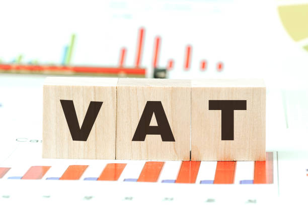 istock word vat with letters on wooden cubes on desk with graphs 1291246552