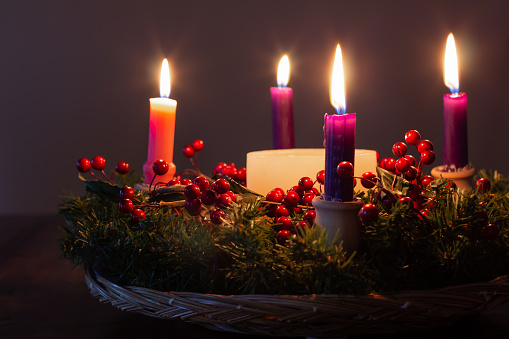 luminous candle on snowy fir tree branch