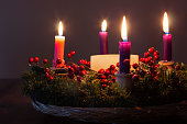 close up of Christmas advent wreath with candles lit