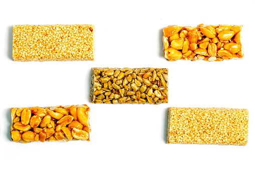 Cereal granola bar with nuts and dry fruit berries. Energy healthy snack. Protein muesli bars isolated on white background. Top view