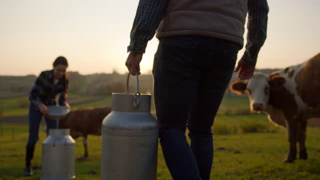 SLO MO Conceptual shot of buying milk from a local farmer