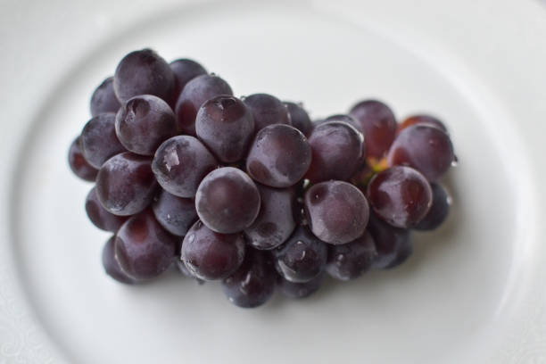 istock juicy grapes on white plate 1291248264