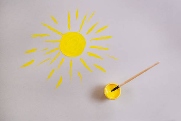 istock yellow sun drawn on gray paper. 1291250096