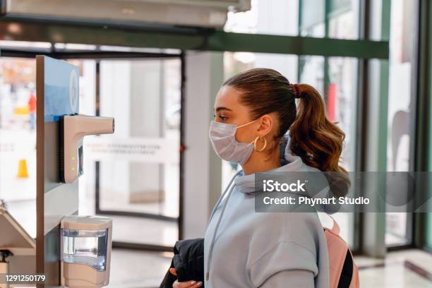 Medical Staff Are Checking The Temperature Of Woman Before Entering The Area With An Epidemic Covid19 Stock Photo - Download Image Now
