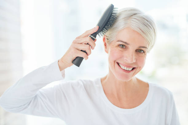healthy hair requires daily care - senior getting groomed studio imagens e fotografias de stock