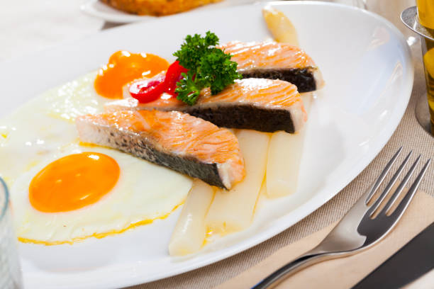 istock Fried eggs with salmon and asparagus 1291251201
