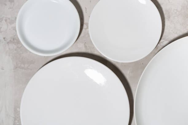 istock set of clean white plates on white background, top view closeup 1291252804