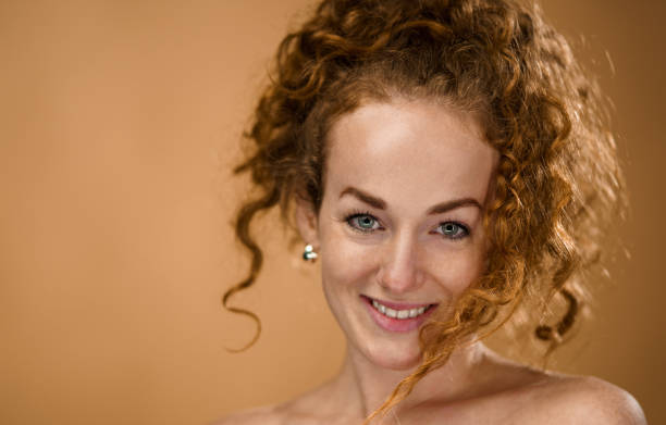 istock Topless young woman in a studio looking at camera, beauty concept. 1291253027