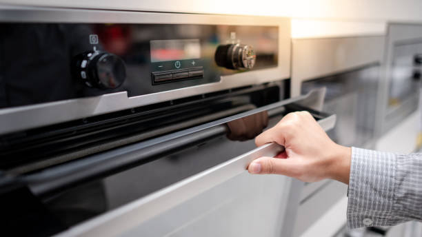 istock Male hand opening oven door 1291255761
