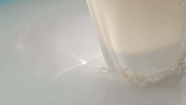 SUPER SLO MO Pouring and spilling milk off the bucket