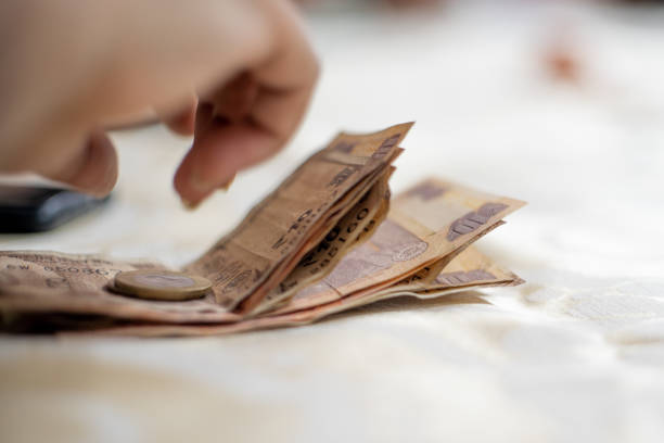 istock Indian currency rupee notes and coins placed on table showing payments, money, saving and gambling in families as they play cards on diwali 1291259945