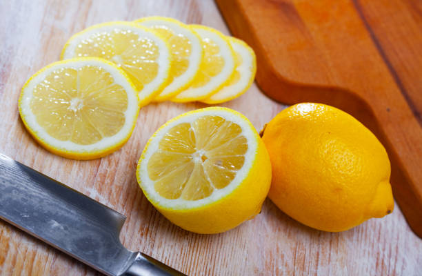 istock Lemon slices on wooden cutting board 1291260946