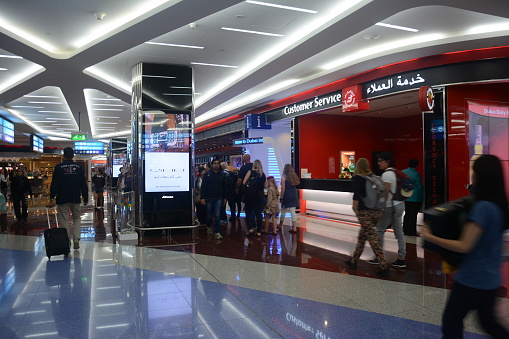 People walking and passing by at the stores in Dubai International Airport Terminal before COVID-19