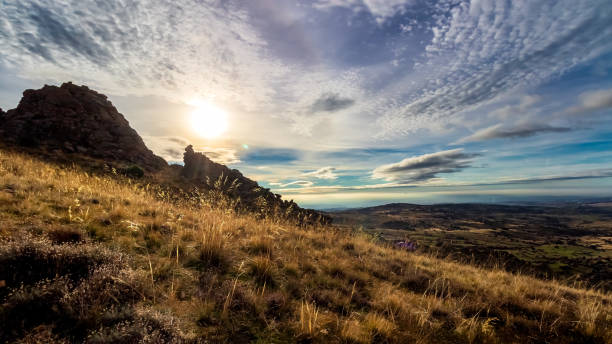 istock Dramatic dark mountain Madrid landscape with clouds and sun in front, rocks and plants. 1291262343