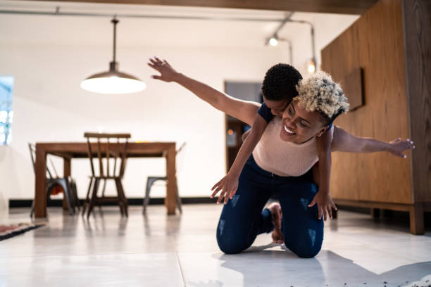 Mother playing with son at home