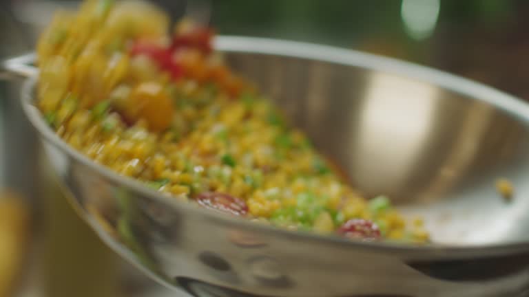 SLO MO CU Fresh vegetables being tossed in a skillet