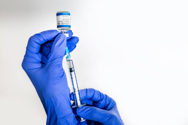 istock Nurse preparing an injection with a COVID-19 vaccine 1291265874