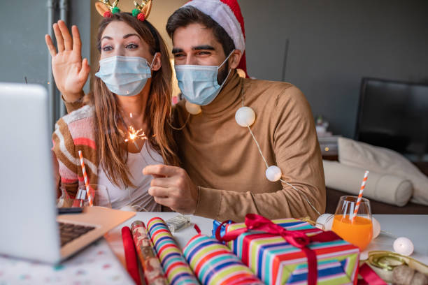 istock Couple at home with protective face mask celebrating Christmas 1291267616