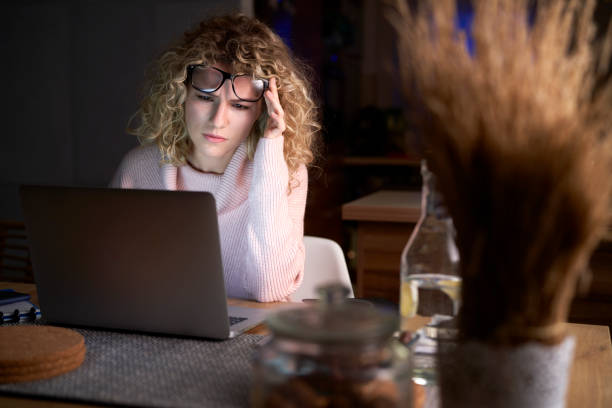 istock Frustrated woman working on laptop till late at work 1291270119