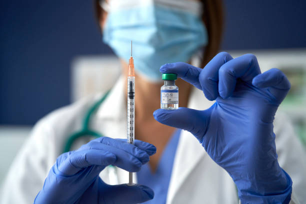 Vaccine and syringe for prevention and treatment from COVID-19 stock photo