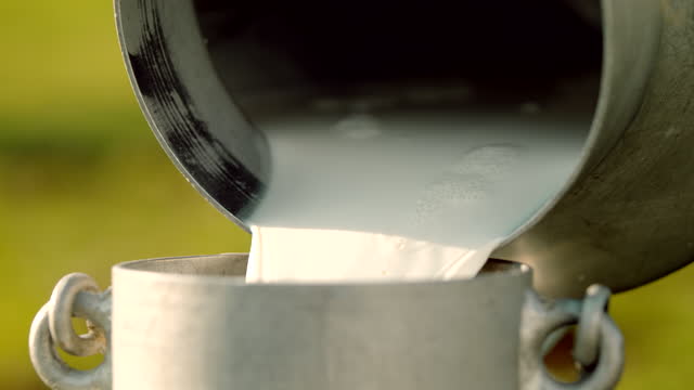 SUPER SLO MO Pouring milk from one barrel to another