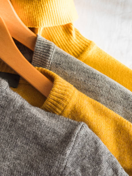 istock Yellow illuminated color and gray winter sweaters 1291274415