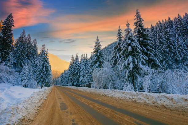 istock road through mountain landscape in winter 1291276457