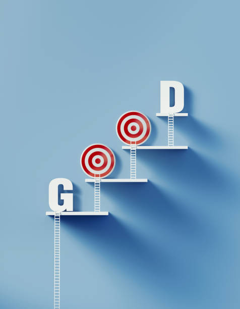 istock White Ladders Leans over A Bull's Eye Target and Writes Good on Blue Wall 1291279389