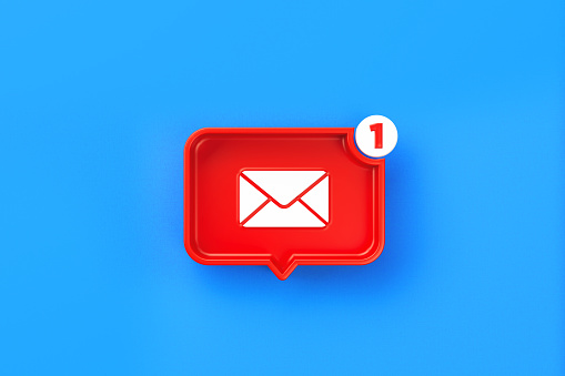 Red chat bubble with email symbol on blue background. Horizontal composition with copy space.